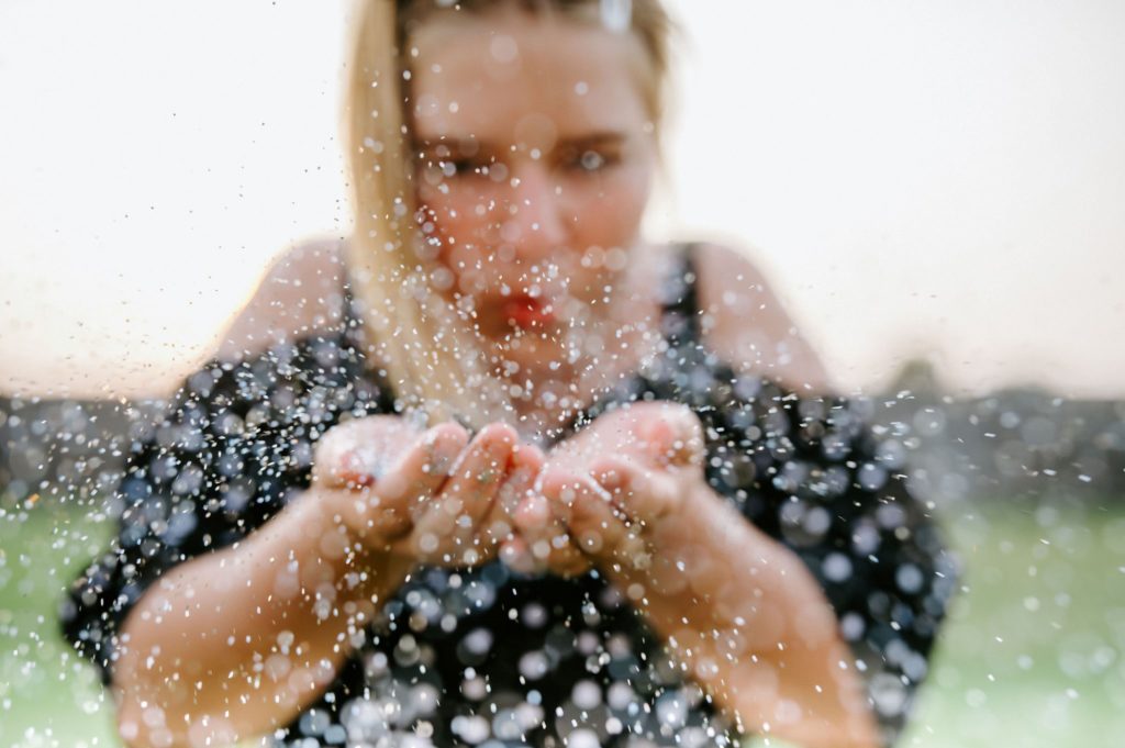 Girl blowing glitter