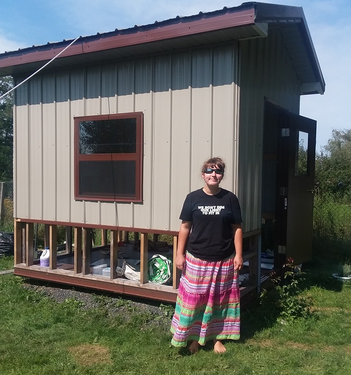 Girl building mini barn for Construction class