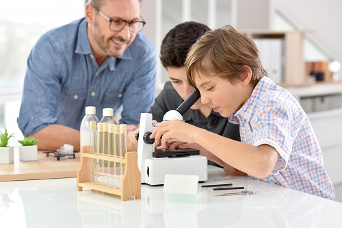 Children doing science experiments with dad