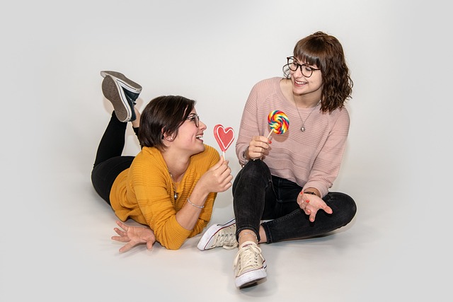 Two teen girls with lollipops