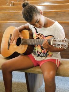 Girl playing a guitar