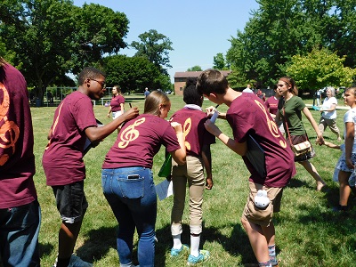 Students at Choral Camp sign each others tee shirts