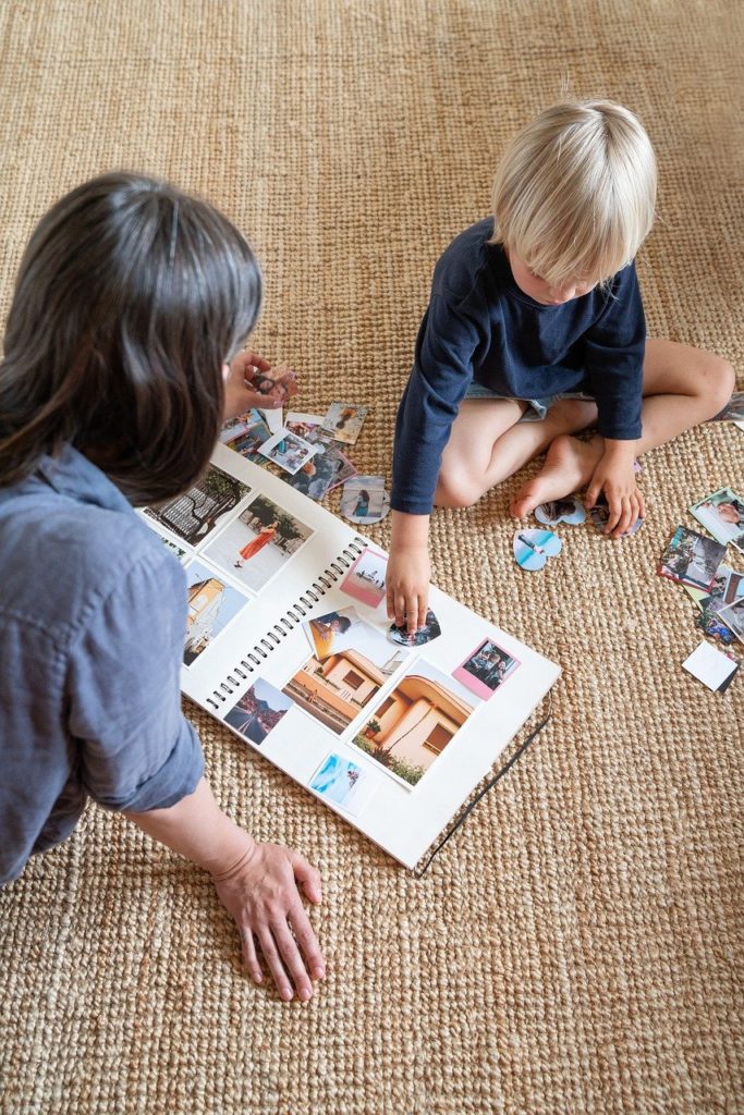 A mother and child making a scrapbook